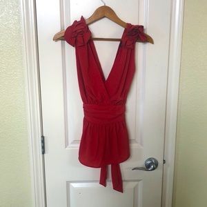 Sleeveless blouse with floral shoulder accents